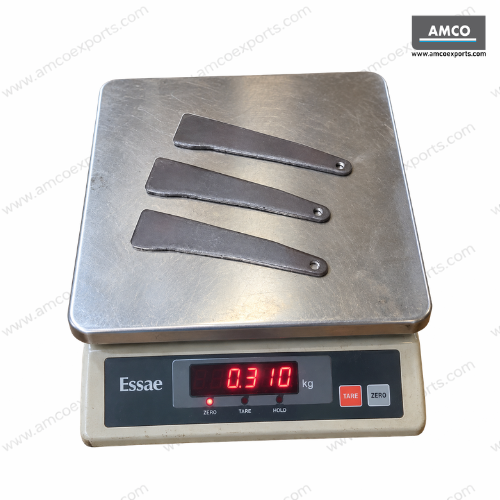 Three pressed steel ringlock wedges weighing approximately 310 grams on a digital weighing scale
